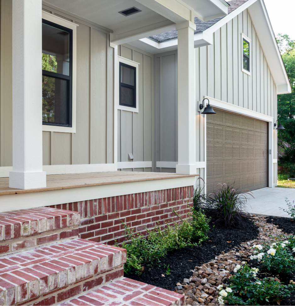 A custom house with a front porch and brick stairs