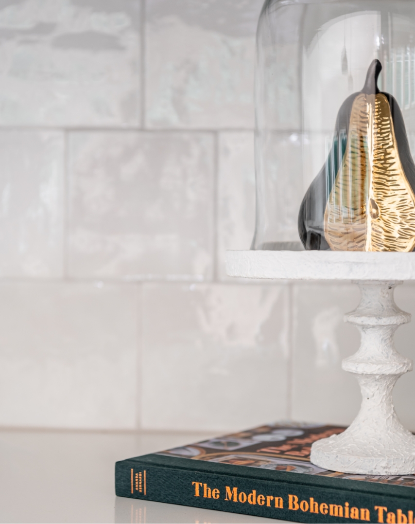 A design book on a white kitchen counter