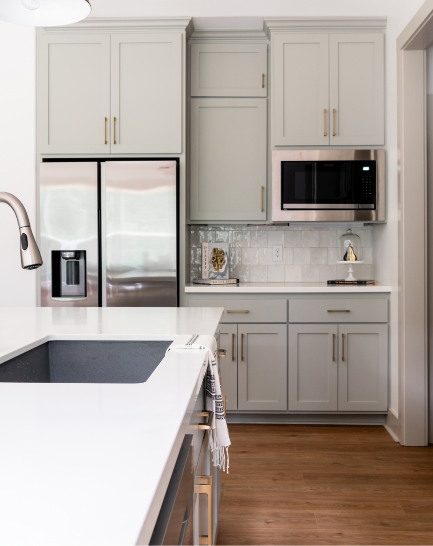 A kitchen with a refrigerator and sink in the kitchen island