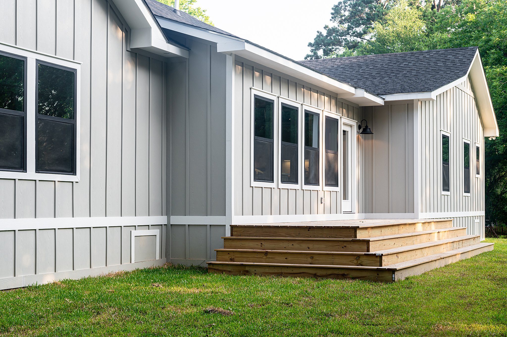 A wooden deck on the back of a house.