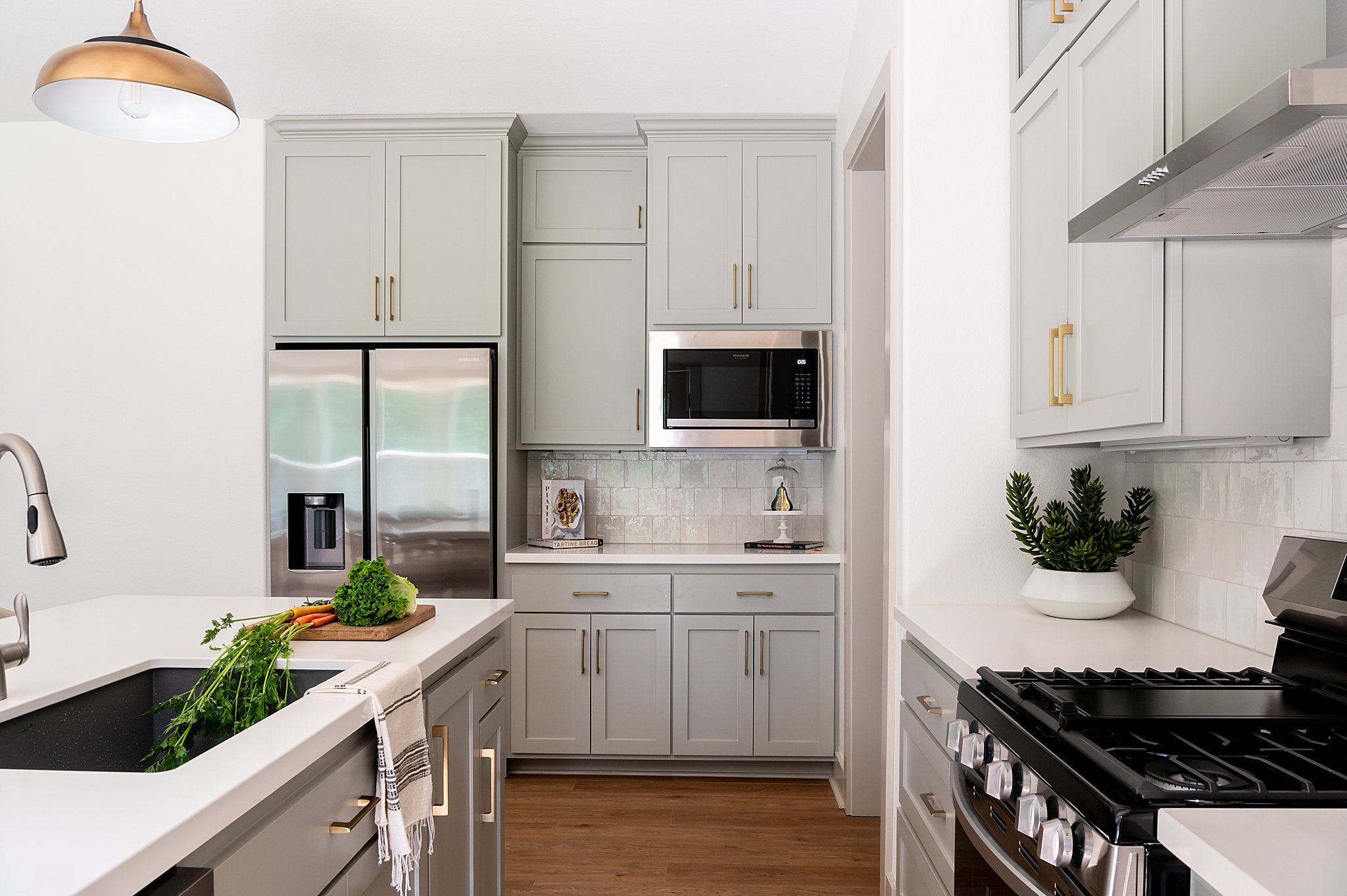 A white kitchen with a stove and sink