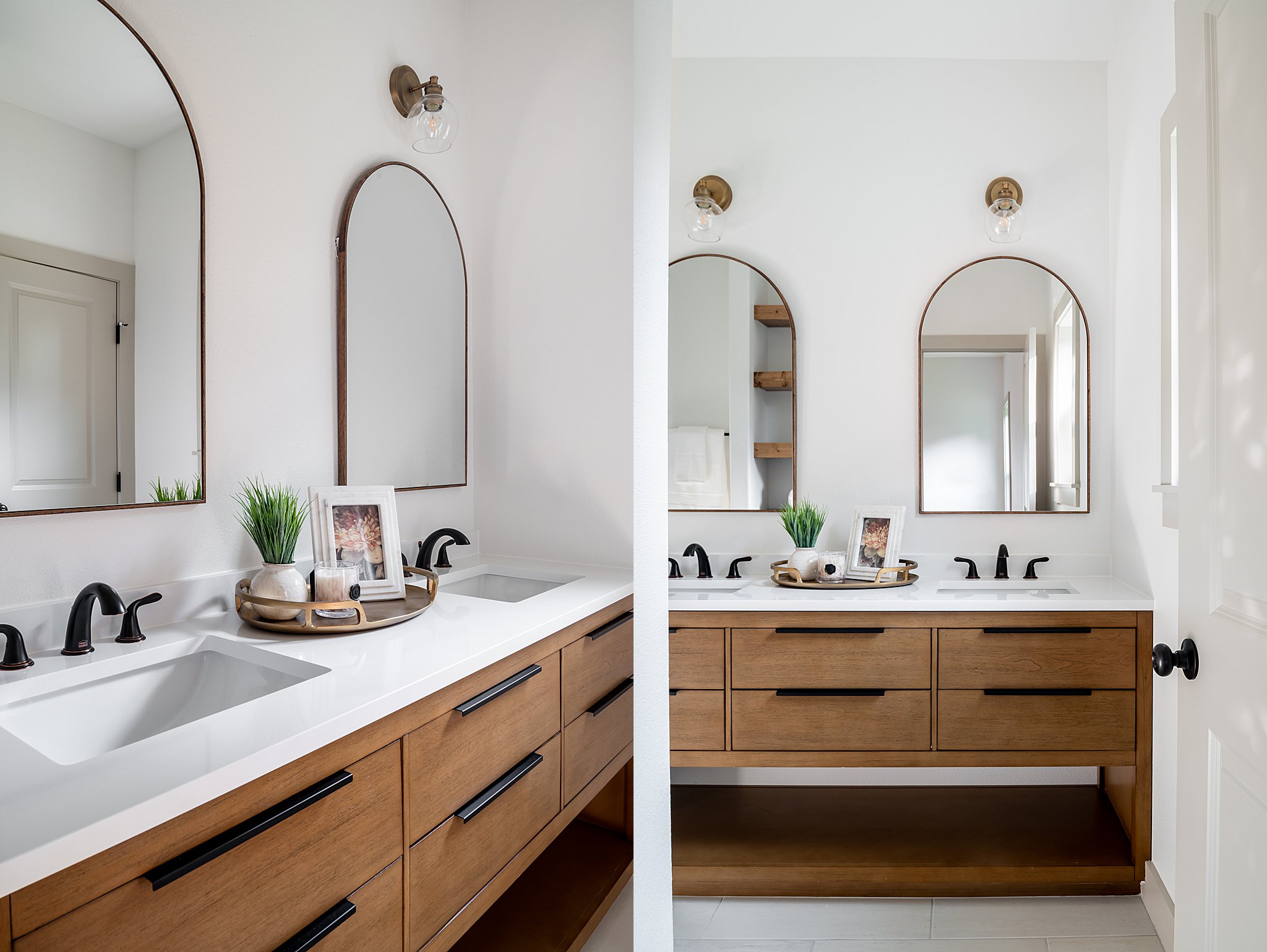 A bathroom with two sinks and two arched mirrors