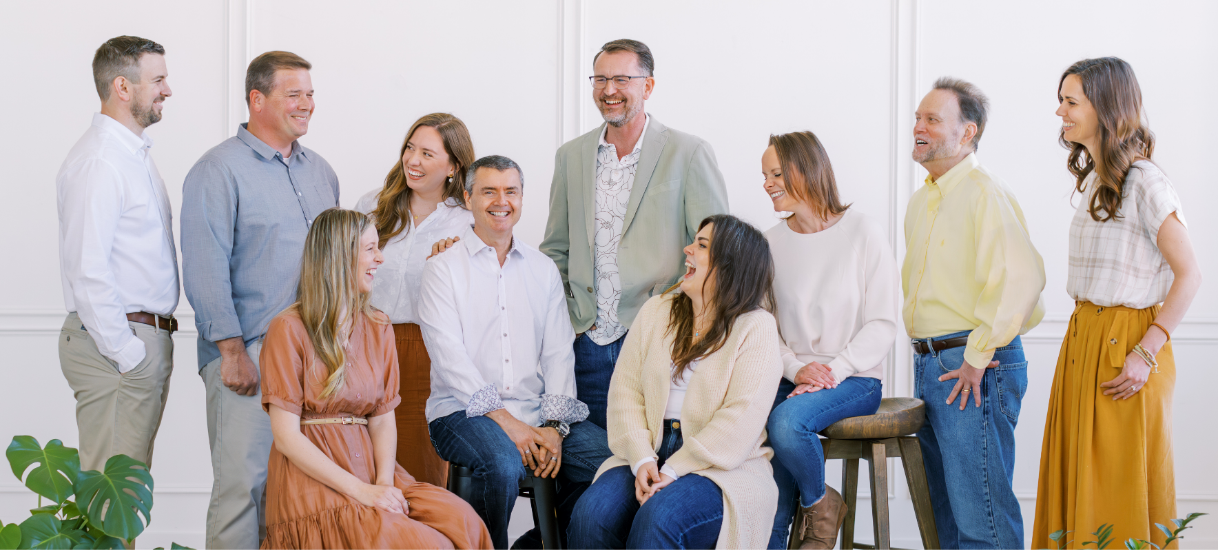 A group of people smiling and laughing candidly in a group photo