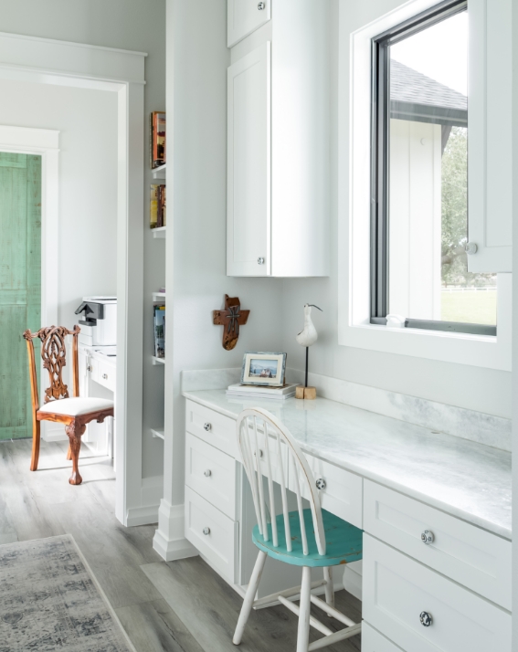 A bathroom with two sinks and two arched mirrors