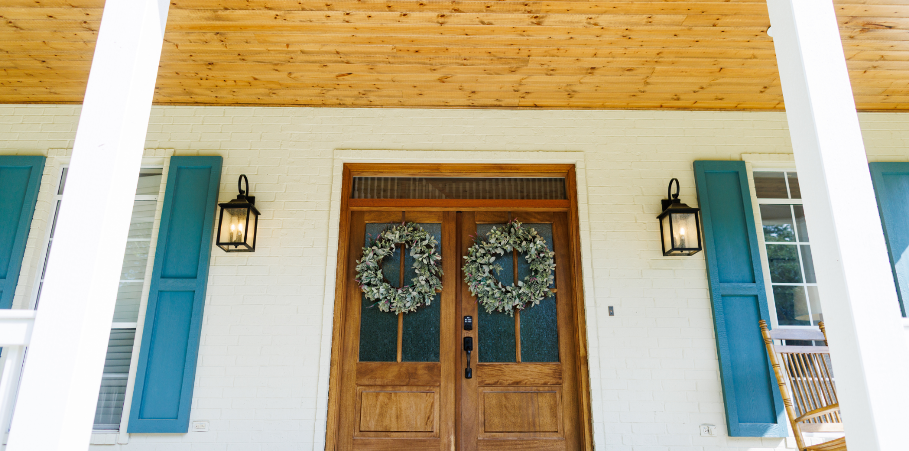A custom-built home with a tree in the front yard.